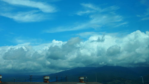 Scenic view of mountains against blue sky