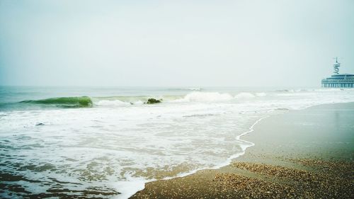 Scenic view of beach against clear sky