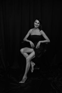 Portrait of woman sitting on bed