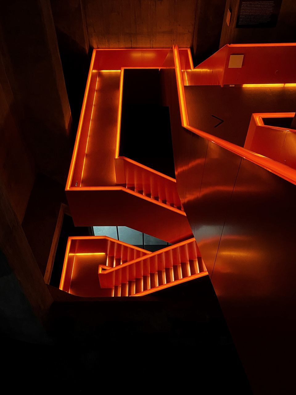 HIGH ANGLE VIEW OF ILLUMINATED STAIRCASE IN BUILDING
