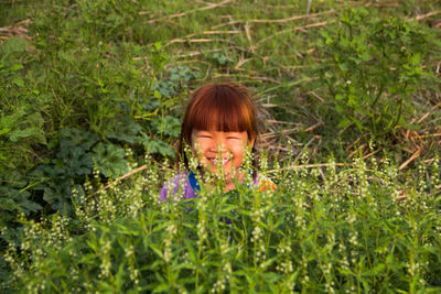 Smiling girl by plants