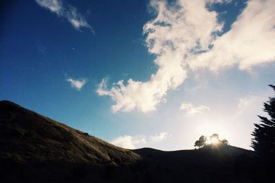 Low angle view of mountain range against cloudy sky