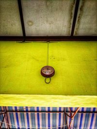 High angle view of yellow lights hanging on wall