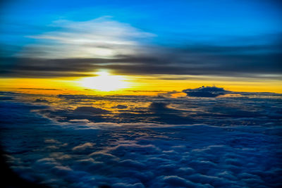 Scenic view of dramatic sky over sea during sunset