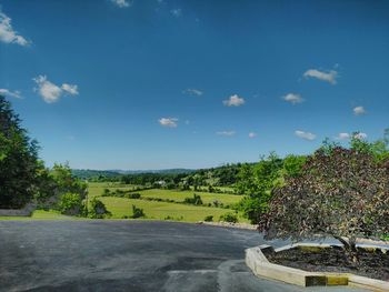 Scenic view of landscape against blue sky