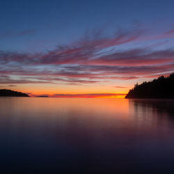 Scenic view of lake against orange sky