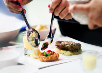 Cropped hand of person preparing food