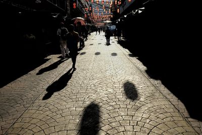 Shadow of man walking on road