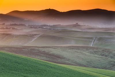 Scenic view of field against sky during sunset