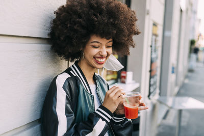 Portrait of young woman drinking coffee