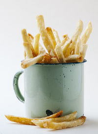 Close-up of burger on table against white background