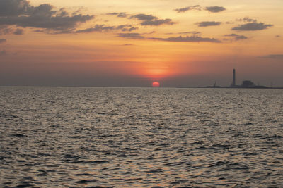 Scenic view of sea against orange sky