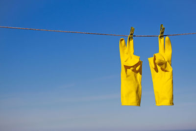 Low angle view of clothes hanging against clear sky