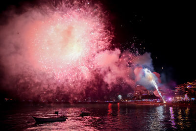 Low angle view of firework display at night