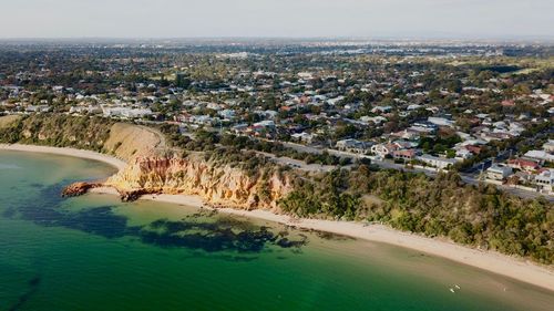 High angle view of buildings and trees against sky
