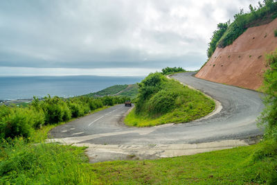 View of road by sea against sky