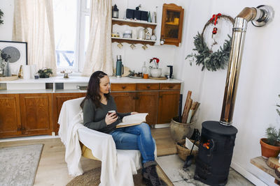 Young woman sitting on sofa at home