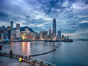Illuminated buildings in city against sky
