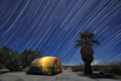 Scenic view of tent against sky at night