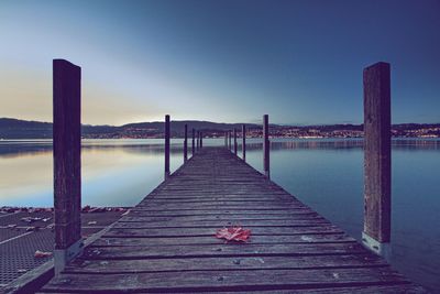 Pier over lake against sky