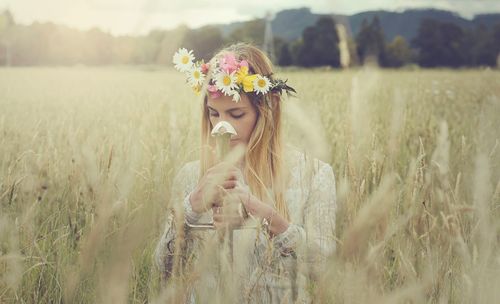 Young woman standing on grassy field