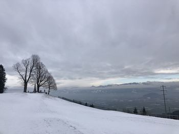 Snow covered field against sky