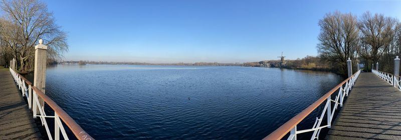 Scenic view of river against clear blue sky