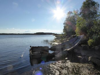 Scenic view of sea against bright sun