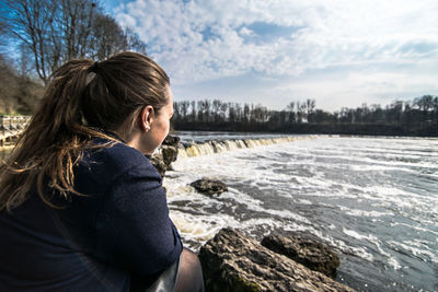 Woman looking at river