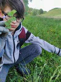 Full length of boy looking away on field