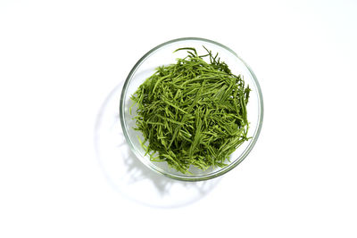 High angle view of vegetables in bowl against white background