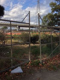 Chainlink fence against cloudy sky