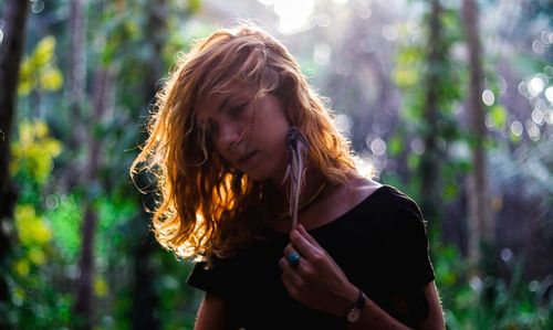 Beautiful woman standing in forest