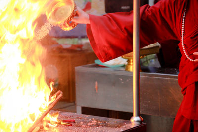 Midsection of man preparing food