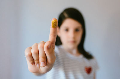 Cropped hand of woman gesturing against white background