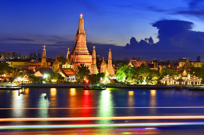 Illuminated temple against sky at night