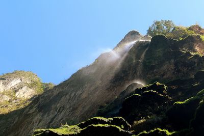 Scenic view of mountains against clear blue sky