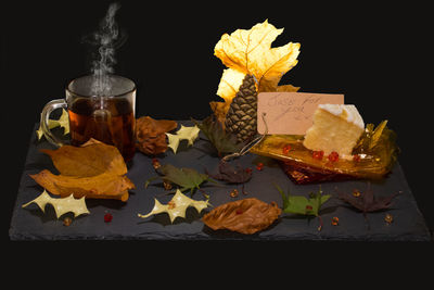 Close-up of autumn leaves on table