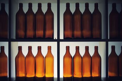 Close-up of bottles arranged on shelves