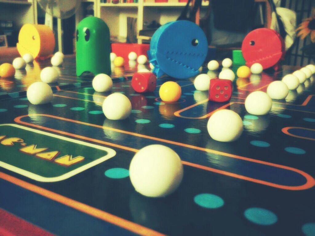 multi colored, indoors, illuminated, variation, colorful, close-up, communication, still life, in a row, no people, selective focus, focus on foreground, text, ball, number, circle, balloon, large group of objects, high angle view, sport