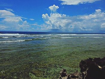 Scenic view of sea against cloudy sky