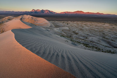 Scenic view of desert against sky during sunset