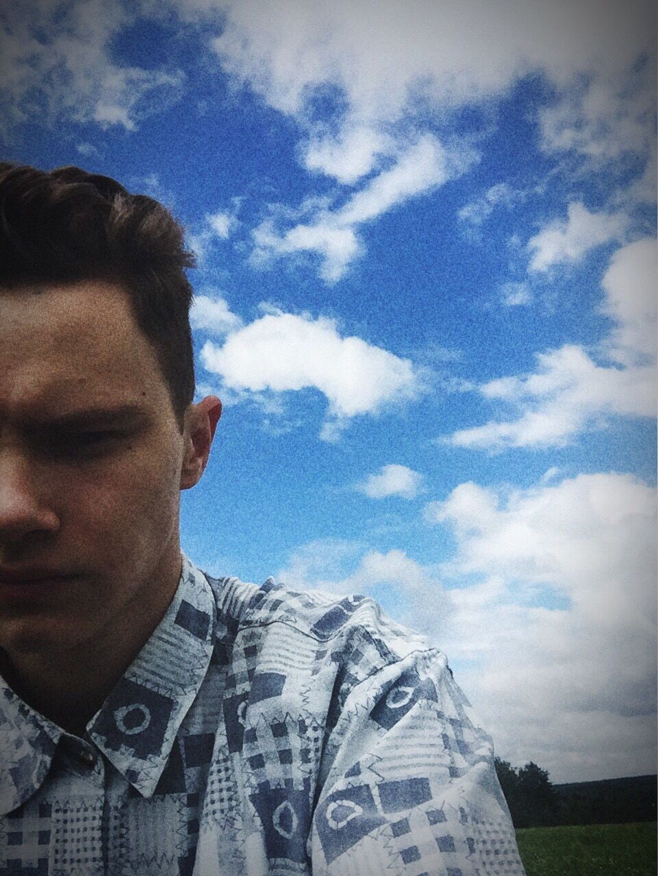 sky, low angle view, cloud - sky, headshot, young adult, leisure activity, young men, person, lifestyles, cloud, high section, handsome, day, human face, focus on foreground, beauty in nature