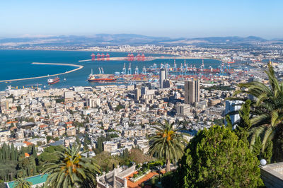 High angle view of city by sea against sky