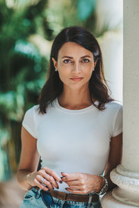 Portrait of young woman sitting on table