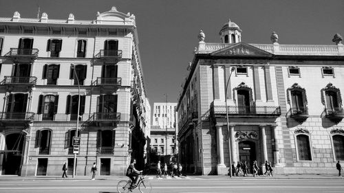 People in city against sky