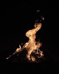 Low angle view of fire against black background