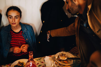 Young couple sitting on table at restaurant