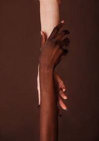 Low section of woman with hands against gray background