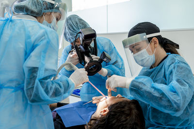 Surgeon with nurses operating patient in surgery room at hospital